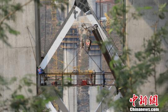 玉磨铁路(中国至老挝国际通道中国段)元江双线特大桥施工现场，工作人员正在桥墩间进行施工。 陈于飞 摄